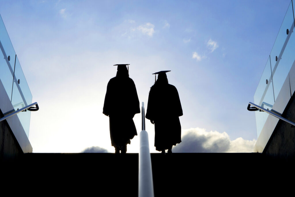 Two graduates follow FAFSA tips for student financial aid.