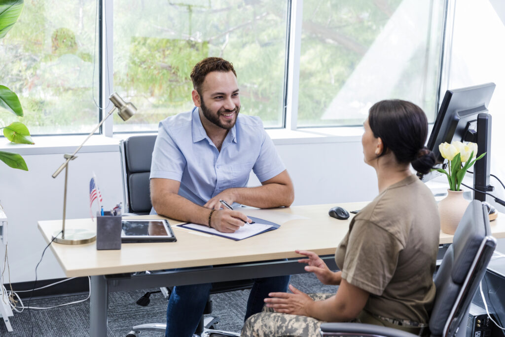 Advisor speaks with military woman on careers for veterans.